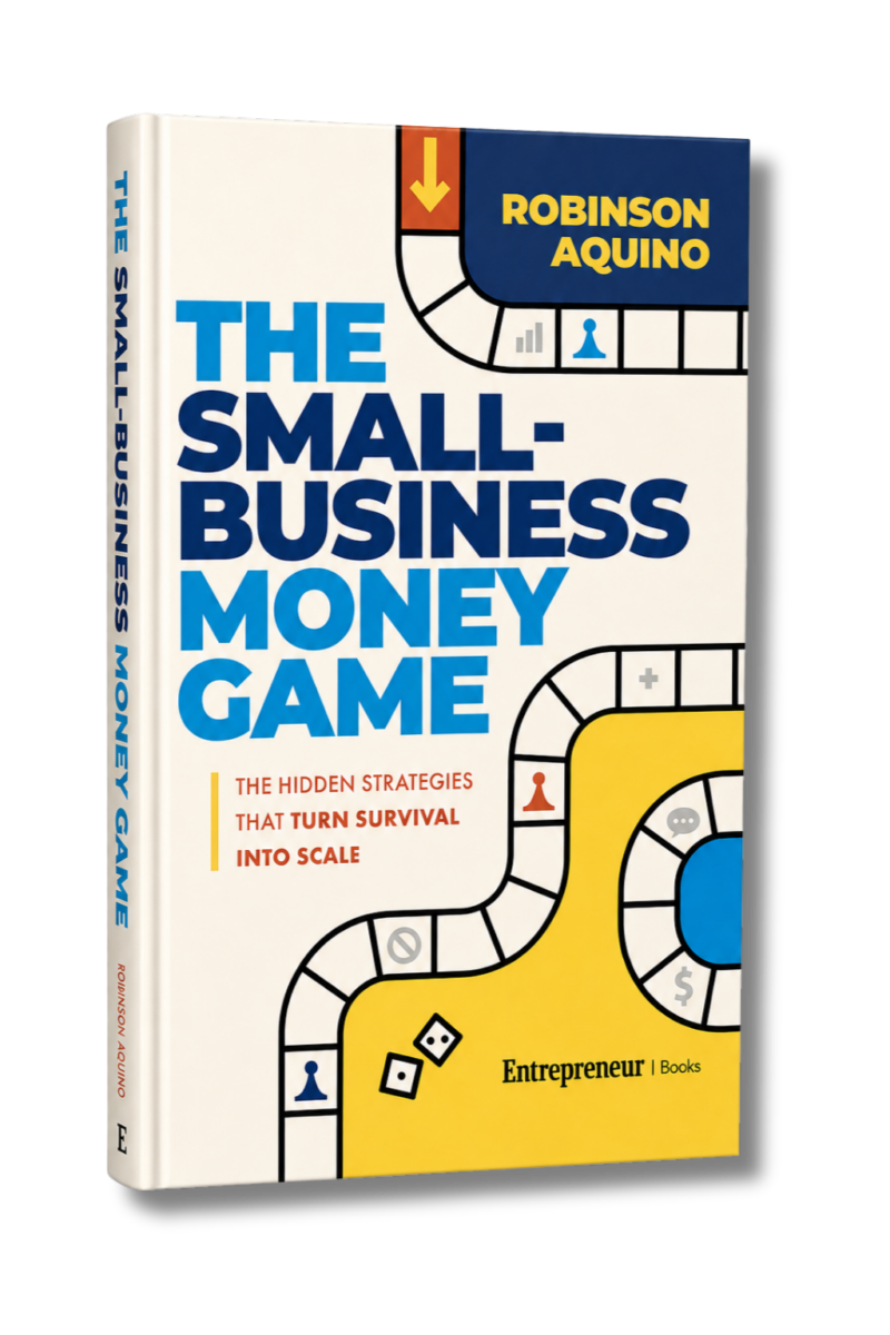 3D product image of The Small-Business Money Game by Robinson Aquino, shown as a standing book with a cream cover, bold blue title text, yellow and navy game board graphics, dice, pawn icons, and “Entrepreneur | Books” branding at the bottom.